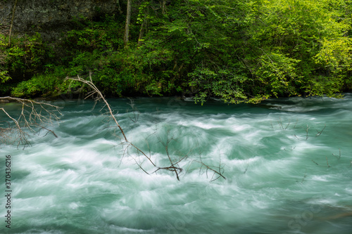 Greer Spring - A spring bursting up from the ground adding to the flow of a river. photo