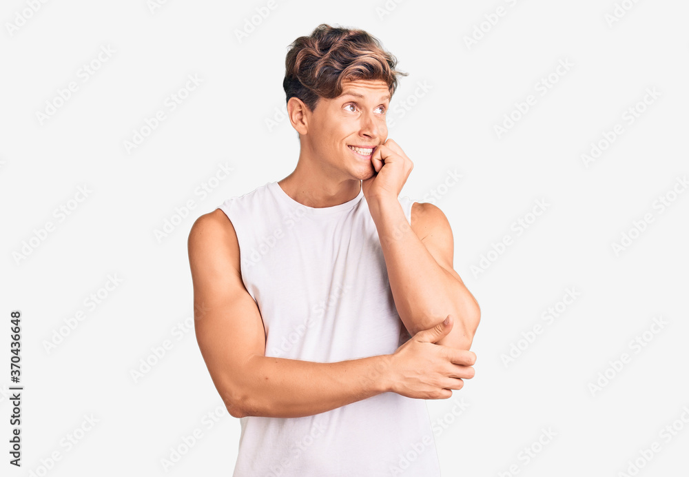 Young handsome man wearing sleveeless t shirt looking stressed and nervous with hands on mouth biting nails. anxiety problem. Young handsome man wearing sleveeless t shirt looking stressed and nervous with hands on mouth biting nails. anxiety problem.