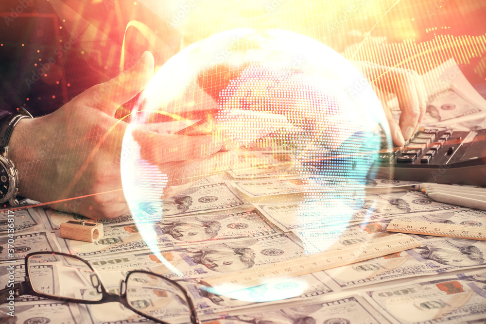 Double exposure of man's hands holding and using a phone and international business theme drawing. Double exposure of man's hands holding and using a phone and international business theme drawing.