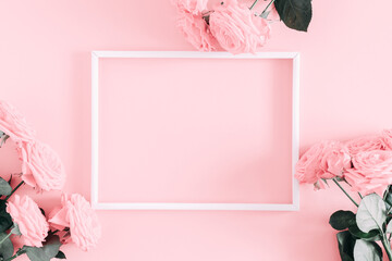 Beautiful flowers composition. Photo Frame, pink rose flowers on pastel pink background. Valentines Day, Easter, Birthday, Happy Women's Day, Mother's day. Flat lay, top view, copy space