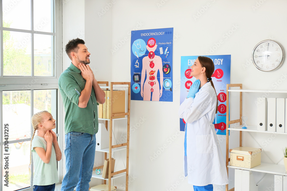 Obraz premium Father with daughter visiting endocrinologist in clinic