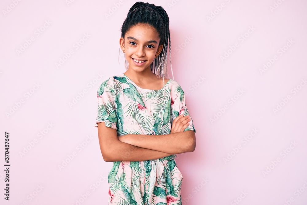 Young african american girl child with braids wearing summer style happy face smiling with crossed arms looking at the camera. positive person. Young african american girl child with braids wearing summer style happy face smiling with crossed arms looking at the camera. positive person.