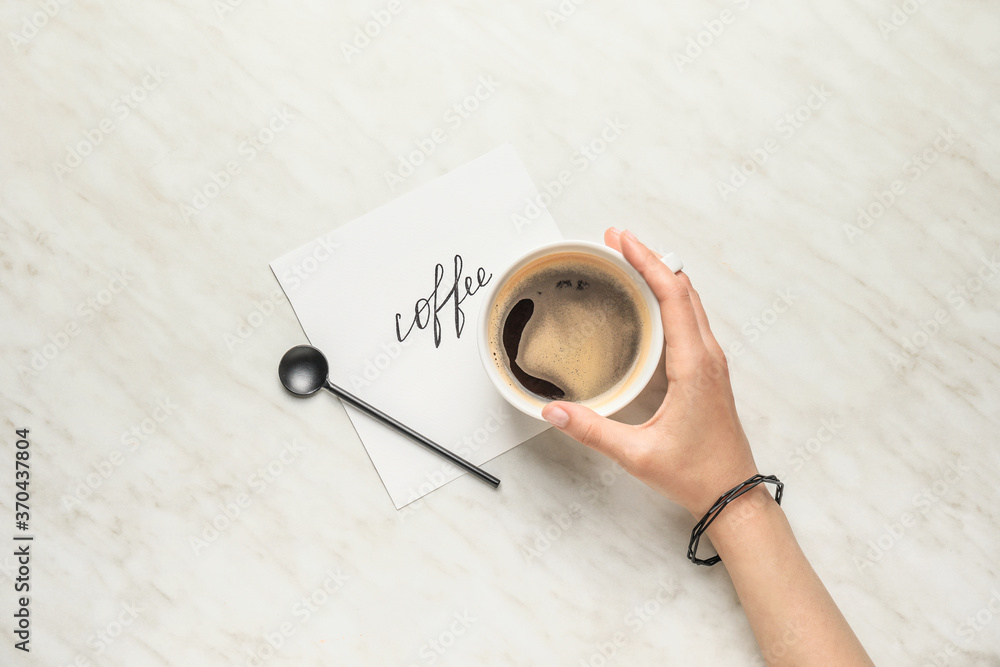 Female hand with cup of coffee on white background Female hand with cup of coffee on white background