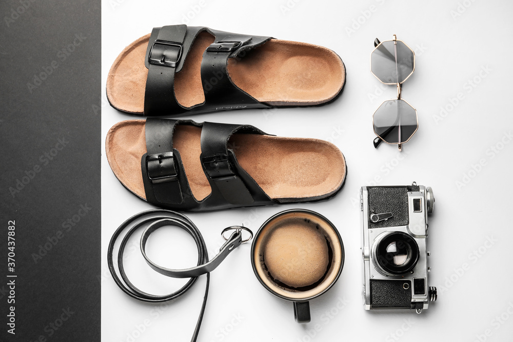Composition with cup of coffee, photo camera and flip-flops on white background