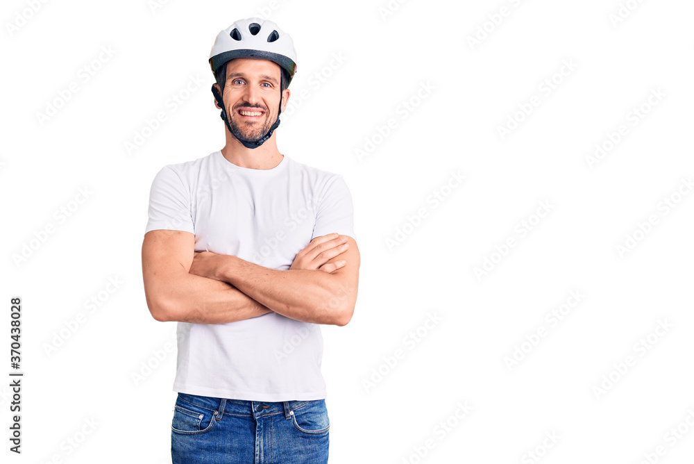 Young handsome man wearing bike helmet happy face smiling with crossed arms looking at the camera. positive person. Young handsome man wearing bike helmet happy face smiling with crossed arms looking at the camera. positive person.