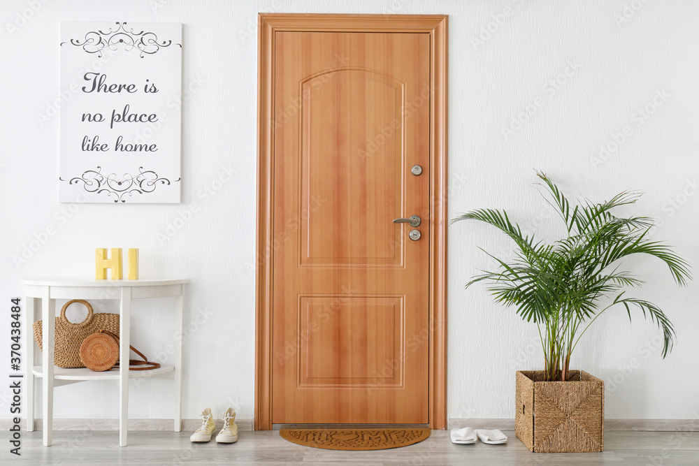 Interior of modern stylish hallway with door mat Interior of modern stylish hallway with door mat