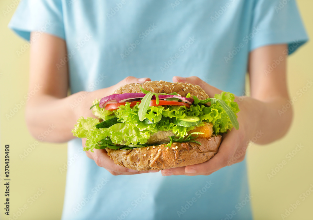 Woman with tasty vegan burger, closeup Woman with tasty vegan burger, closeup