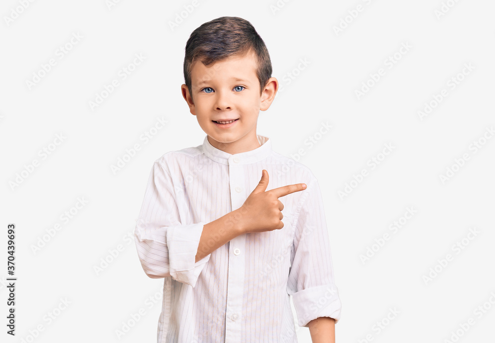 Cute blond kid wearing elegant shirt cheerful with a smile on face pointing with hand and finger up to the side with happy and natural expression Cute blond kid wearing elegant shirt cheerful with a smile on face pointing with hand and finger up to the side with happy and natural expression