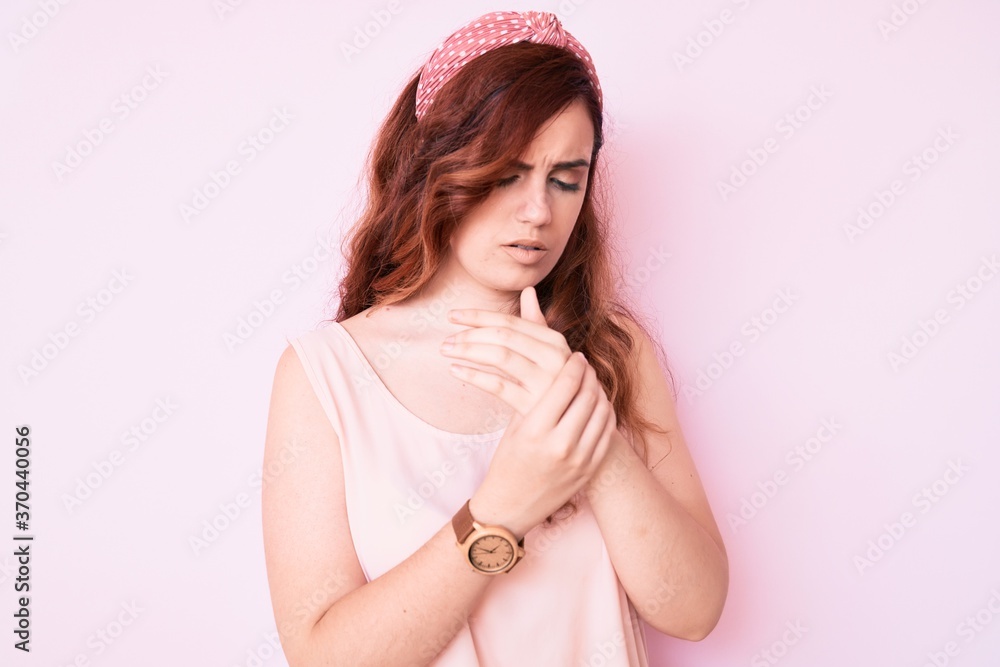 Young beautiful woman wearing casual clothes suffering pain on hands and fingers, arthritis inflammation Young beautiful woman wearing casual clothes suffering pain on hands and fingers, arthritis inflammation