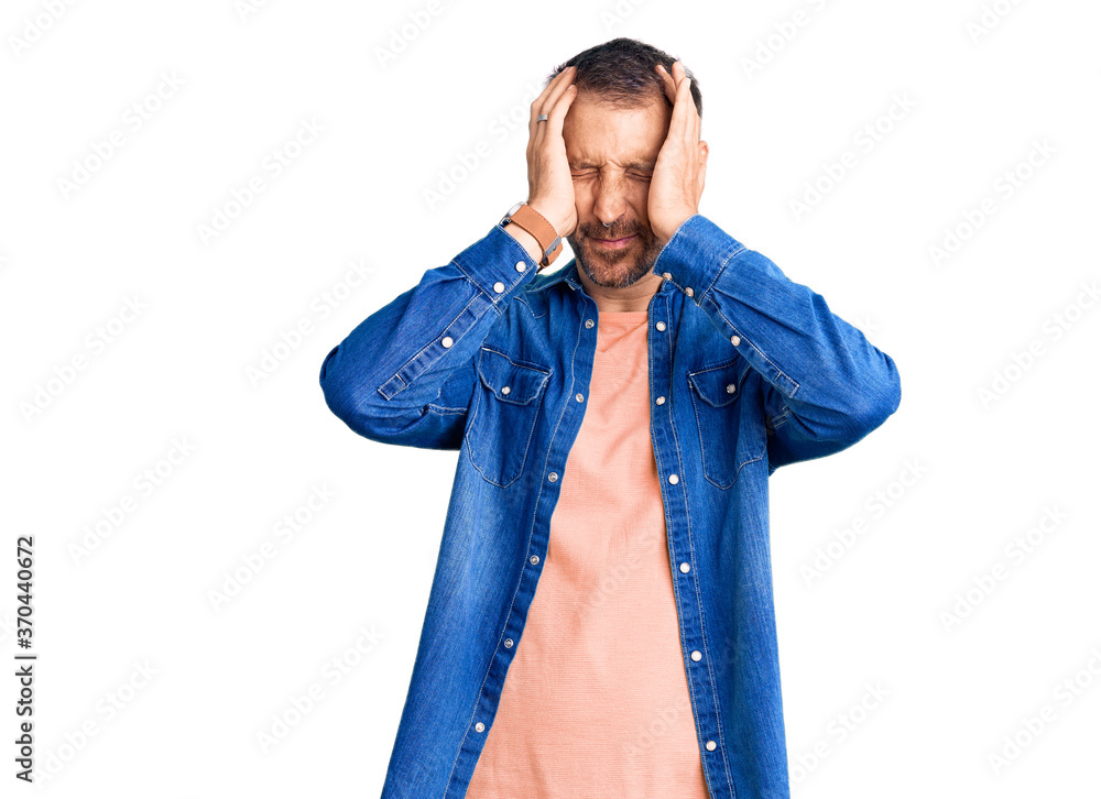 Young handsome man wearing casual clothes suffering from headache desperate and stressed because pain and migraine. hands on head. Young handsome man wearing casual clothes suffering from headache desperate and stressed because pain and migraine. hands on head.