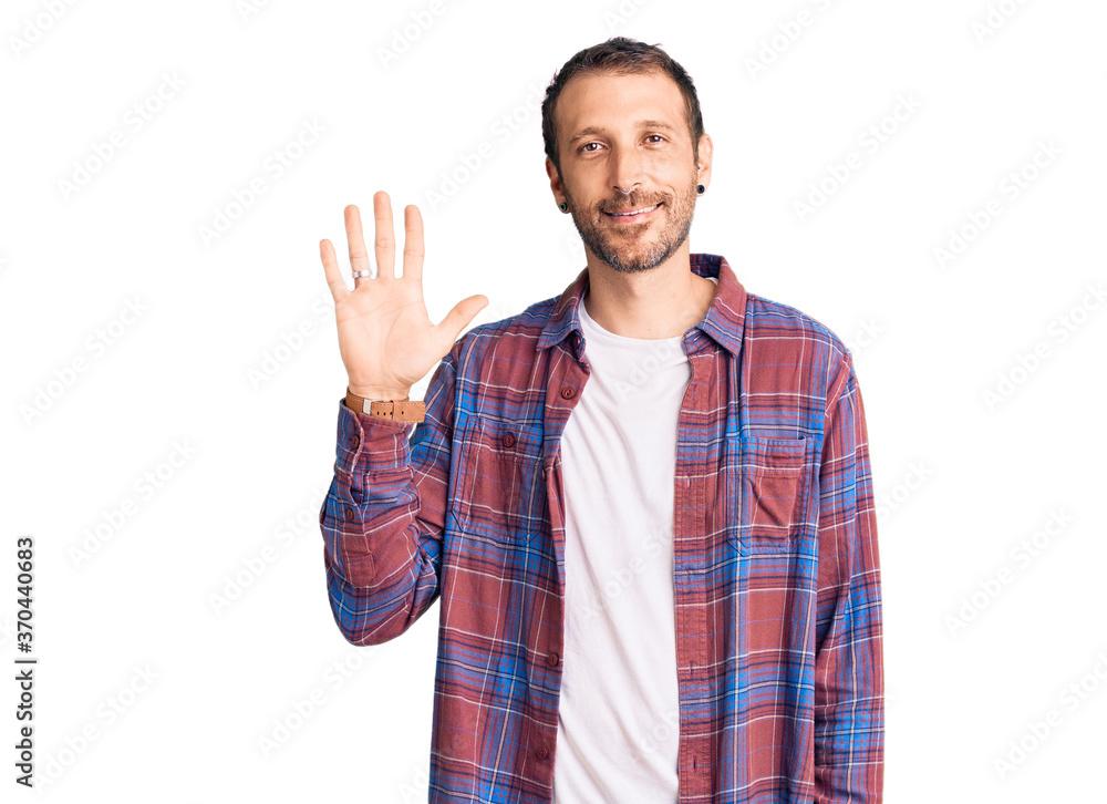 Young handsome man wearing casual clothes showing and pointing up with fingers number five while smiling confident and happy. Young handsome man wearing casual clothes showing and pointing up with fingers number five while smiling confident and happy.