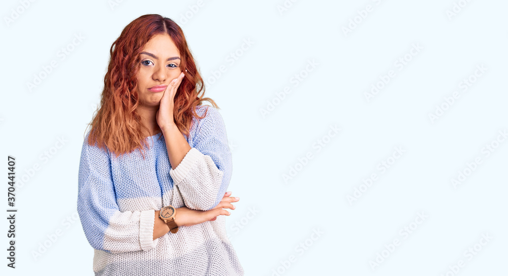 Young latin woman wearing casual clothes thinking looking tired and bored with depression problems with crossed arms. Young latin woman wearing casual clothes thinking looking tired and bored with depression problems with crossed arms.