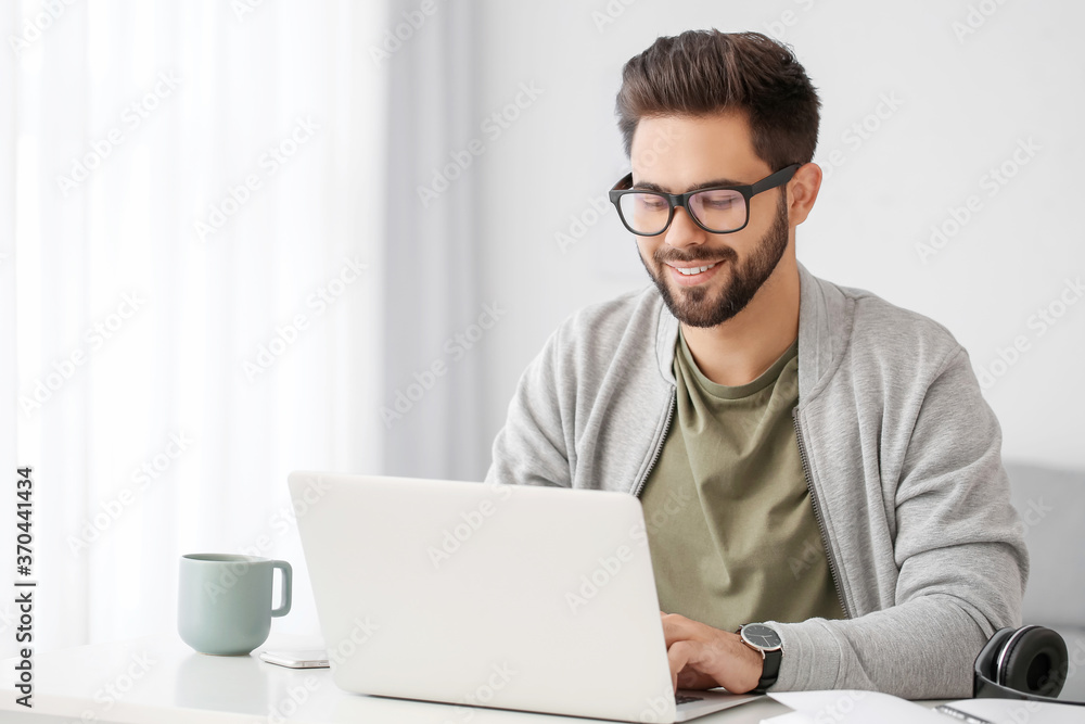Young man using laptop for online learning at home Young man using laptop for online learning at home