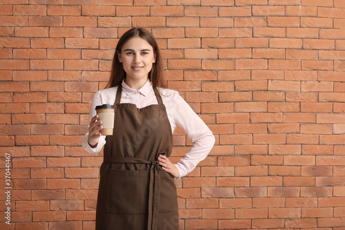 Female barista on brick bac...