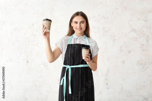 Female barista on light bac...