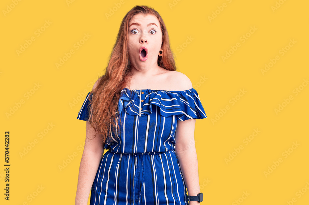 Young beautiful redhead woman wearing casual clothes afraid and shocked with surprise expression, fear and excited face. Young beautiful redhead woman wearing casual clothes afraid and shocked with surprise expression, fear and excited face.