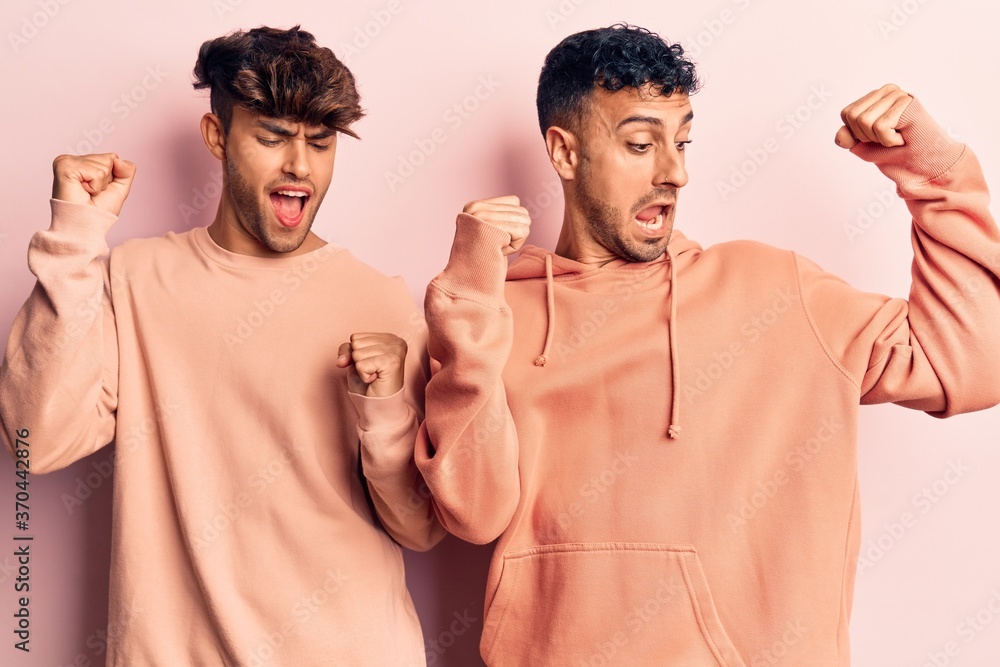 Young gay couple wearing casual clothes dancing happy and cheerful, smiling moving casual and confident listening to music Young gay couple wearing casual clothes dancing happy and cheerful, smiling moving casual and confident listening to music