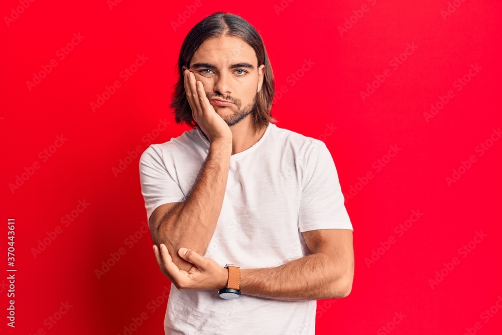 Young handsome man wearing casual clothes thinking looking tired and bored with depression problems with crossed arms. Young handsome man wearing casual clothes thinking looking tired and bored with depression problems with crossed arms.