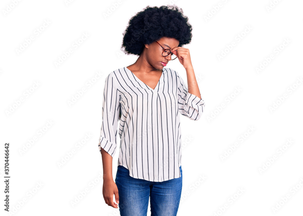 Young african american woman wearing casual clothes and glasses tired rubbing nose and eyes feeling fatigue and headache. stress and frustration concept. Young african american woman wearing casual clothes and glasses tired rubbing nose and eyes feeling fatigue and headache. stress and frustration concept.