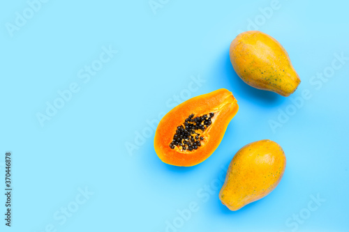 Papaya fruit on blue background.