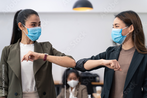 People in office company have elbow greeting during covid pandemic photo
