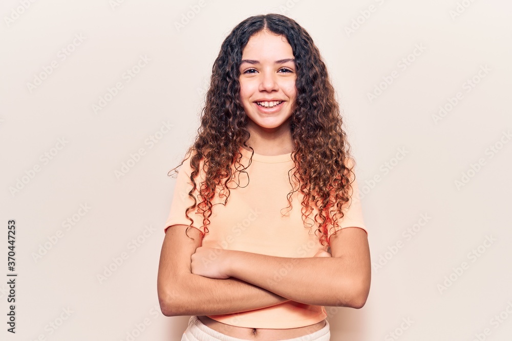 Beautiful kid girl with curly hair wearing casual clothes happy face smiling with crossed arms looking at the camera. positive person. Beautiful kid girl with curly hair wearing casual clothes happy face smiling with crossed arms looking at the camera. positive person.