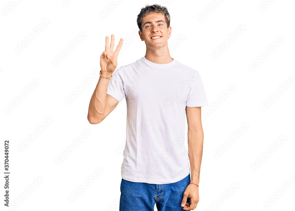 Young handsome man wearing casual white tshirt showing and pointing up with fingers number three while smiling confident and happy. Young handsome man wearing casual white tshirt showing and pointing up with fingers number three while smiling confident and happy.