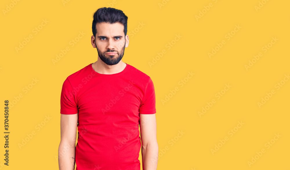 Young handsome man with beard wearing casual t-shirt depressed and worry for distress, crying angry and afraid. sad expression. Young handsome man with beard wearing casual t-shirt depressed and worry for distress, crying angry and afraid. sad expression.