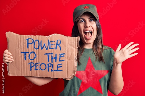 Tableau sur toile Beautiful woman wearing t-shirt with red star communist symbol asking for social
