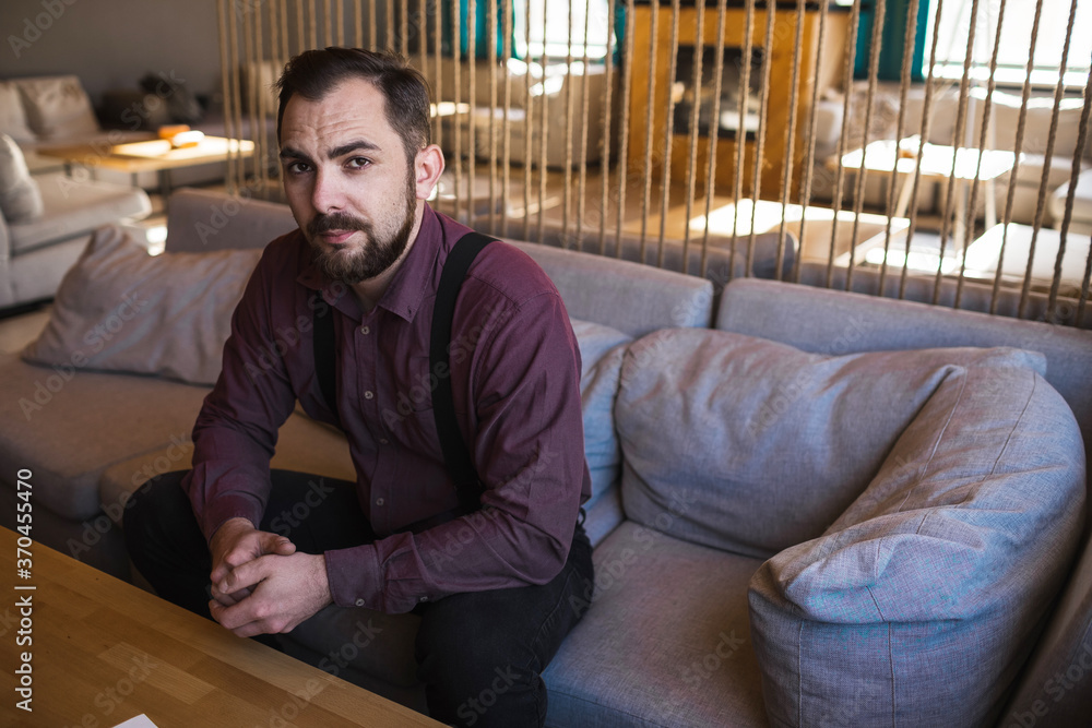 The young man is in a modern stylish cafe. The young man is in a modern stylish cafe.
