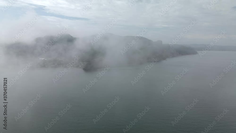 Flying Over The Thick Fog And Revealing The Gaspe Peninsula By The Saint Lawrence Gulf In Quebec, Canada. - aerial drone Flying Over The Thick Fog And Revealing The Gaspe Peninsula By The Saint Lawrence Gulf In Quebec, Canada. - aerial drone