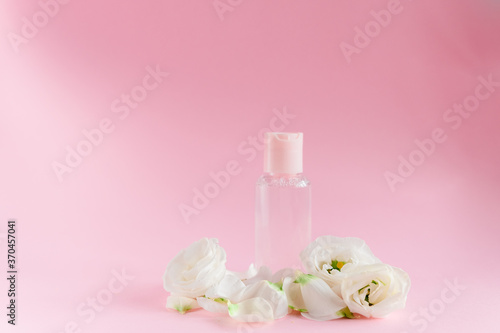 Hand cream with flowers. Delicate skin care concept. Top horizontal view copyspace