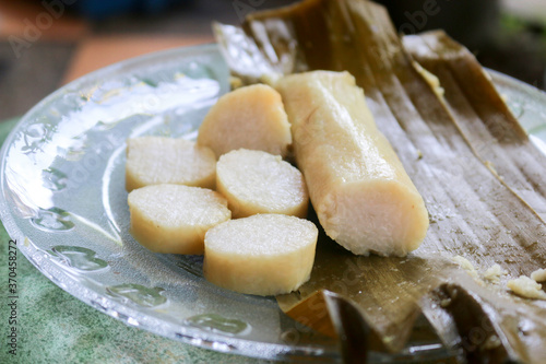 Close up photo of rice cake or commonly called lontong, traditional food wrapped in banana leaf from central java indonesia on a plate