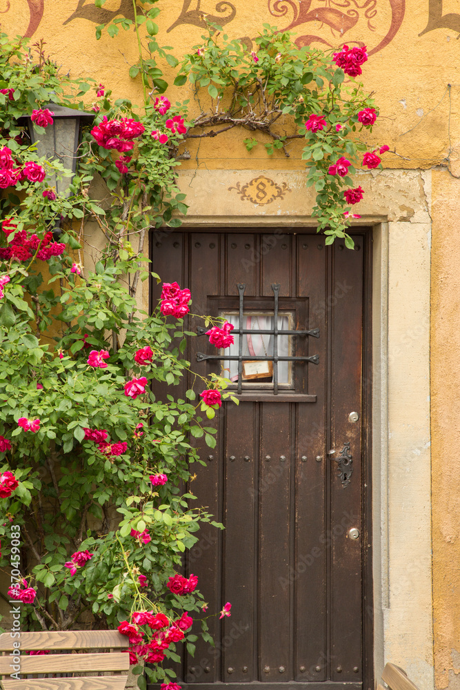A decorated door entry with red flowers on home in Rothenburg ob der Tauber, germany