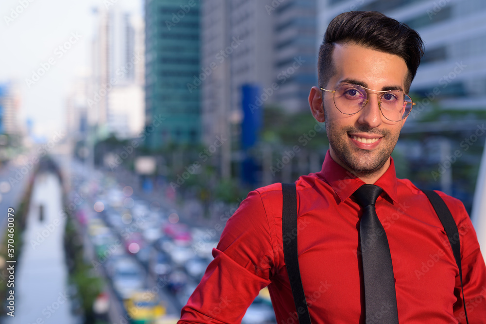 Fototapeta premium Young handsome Persian businessman exploring the city