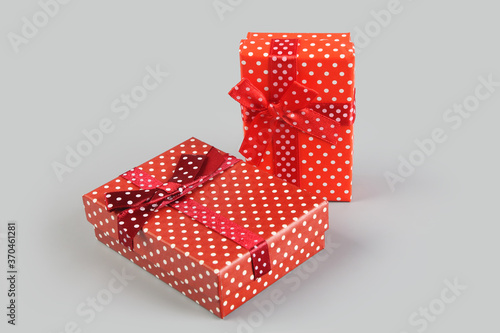 Red color elegant gift box on gray background