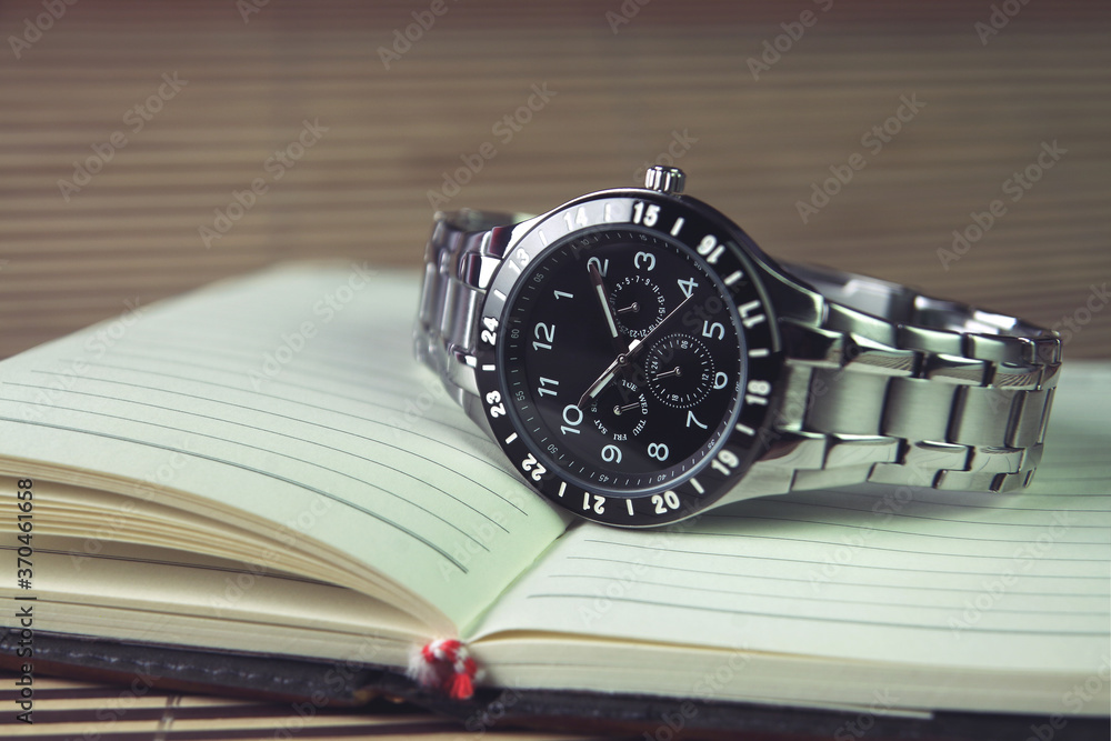 Men's wrist watch on Notebook or Business Planner Men's wrist watch on Notebook or Business Planner