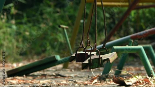 movement of old and rusty swings in playground