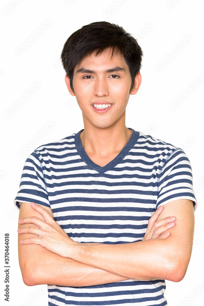 Studio shot of confident young handsome Asian man smiling against white background Studio shot of confident young handsome Asian man smiling against white background