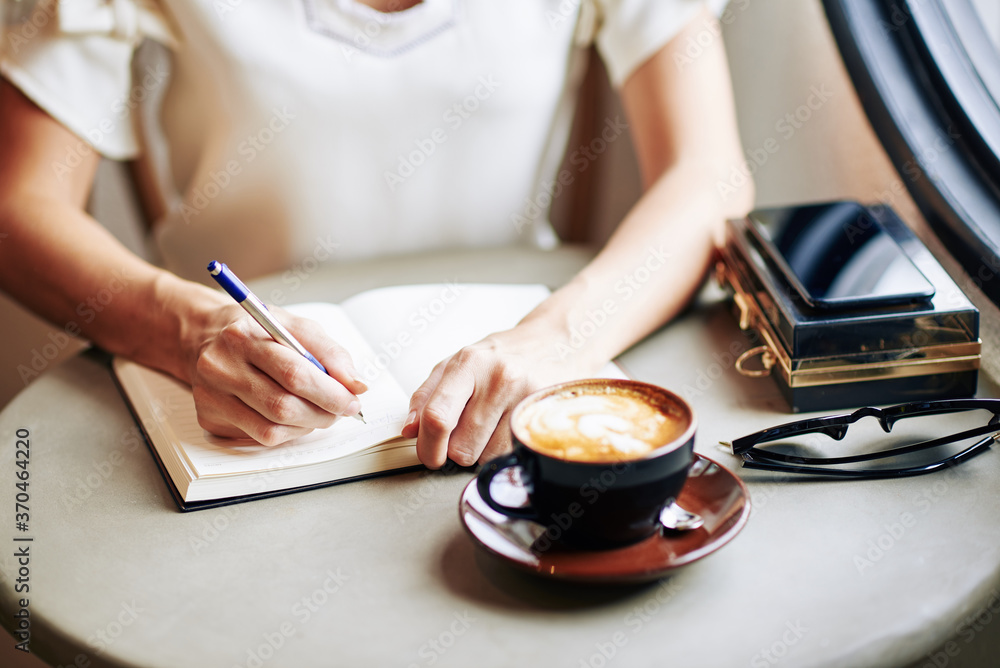 custom made wallpaper toronto digitalClose-up image of woman drinking cup of cappuccino and writing thoughts and ideas in gratitude journal