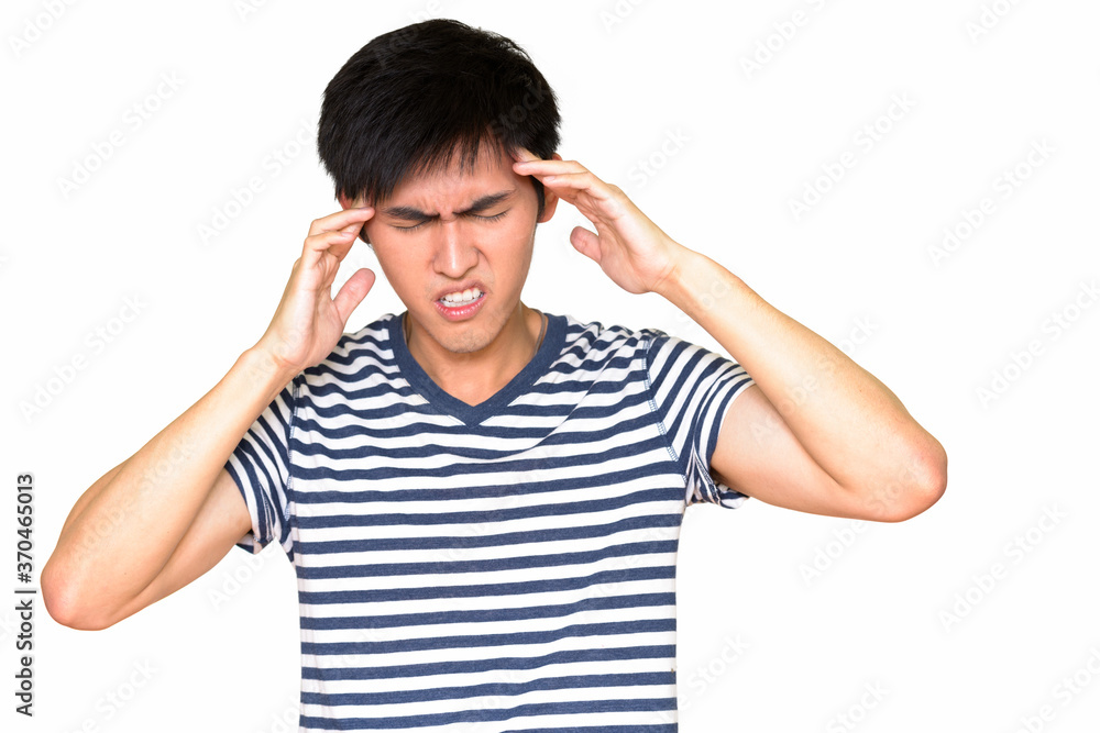 Studio shot of young Asian man having headache isolated against white background Studio shot of young Asian man having headache isolated against white background