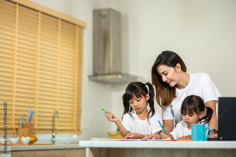 Happy mother and smiling daughter together painting using markers. Mother helping adopted child with art homework. Cheerful mother and asian little girl making painting at home. Happy mother and smiling daughter together painting using markers. Mother helping adopted child with art homework. Cheerful mother and asian little girl making painting at home.