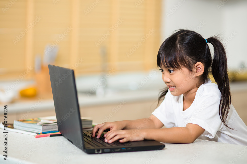 Coronavirus Outbreak. Lockdown and school closures. Schoolgirl watching online education class, happy talking with teacher on the internet at home. COVID-19 pandemic forces children online learning Coronavirus Outbreak. Lockdown and school closures. Schoolgirl watching online education class, happy talking with teacher on the internet at home. COVID-19 pandemic forces children online learning