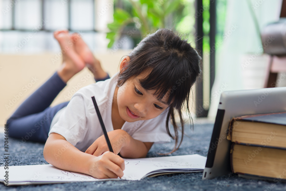 Portrait of preschool kid using tablet for his homework,Soft focus of Child doing homework by using digital tablet searching information on internet,E-learning or Home schooling education concept Portrait of preschool kid using tablet for his homework,Soft focus of Child doing homework by using digital tablet searching information on internet,E-learning or Home schooling education concept