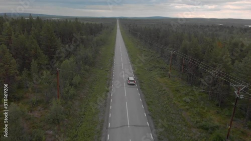 Drone following a silver volvo in northern Swedish landscape photo