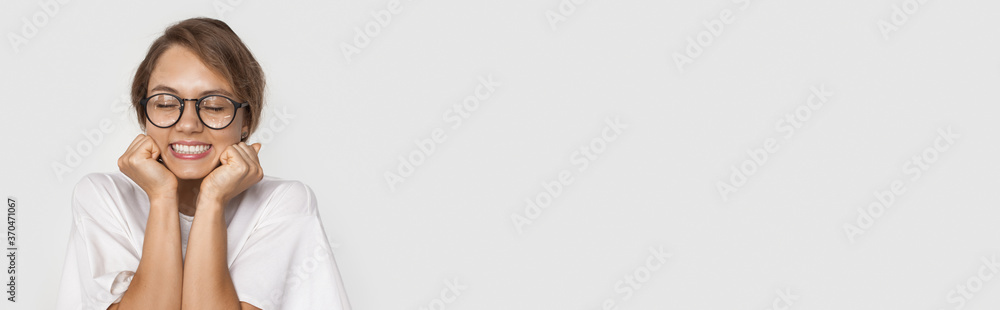 Monochrome photo of a caucasian woman with eyeglasses waiting for a present on a white studio wall with free space Monochrome photo of a caucasian woman with eyeglasses waiting for a present on a white studio wall with free space