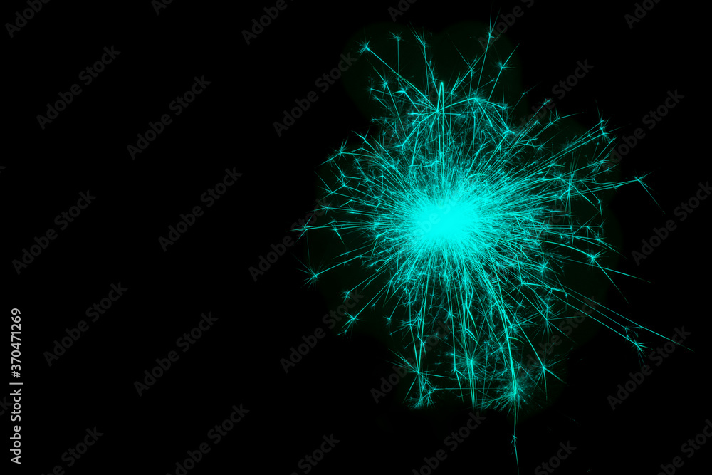 Christmas and New Year party sparkler on black burning colored sparkler, pyrotechnics on a black background Christmas and New Year party sparkler on black burning colored sparkler, pyrotechnics on a black background