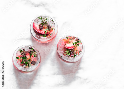 Peaches, fresh thyme, alcohol drink summer cocktail on a light background, top view. Copy space