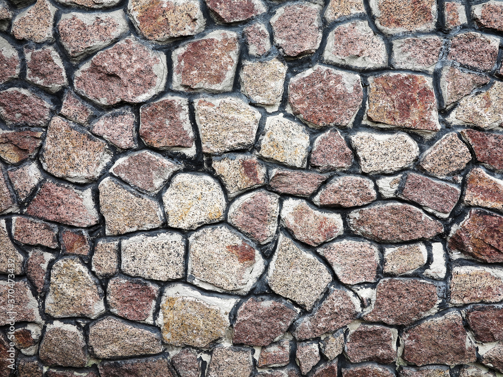 Stone wall background. Background of stone wall of boulders and pebbles Stone wall background. Background of stone wall of boulders and pebbles