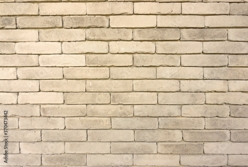 Wall of grey color clay brick in background